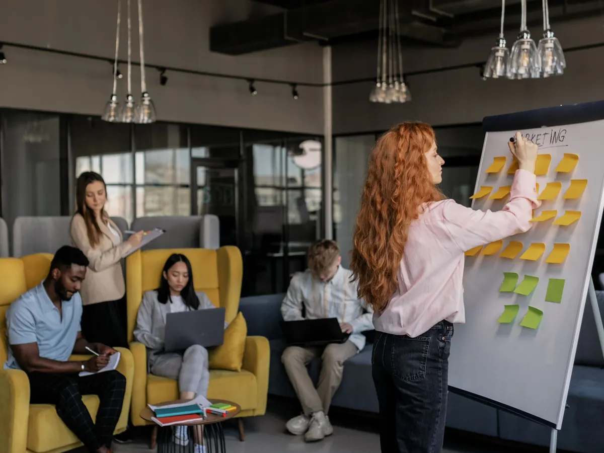 A strategist leading a planning session at a board