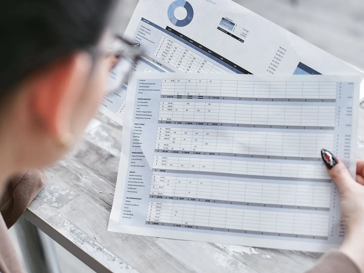 A reviewer reading down a printed results table
