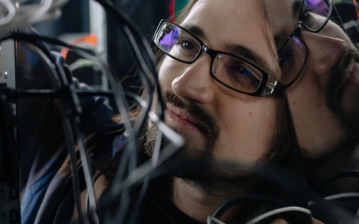An engineer working through a tangle of network cables