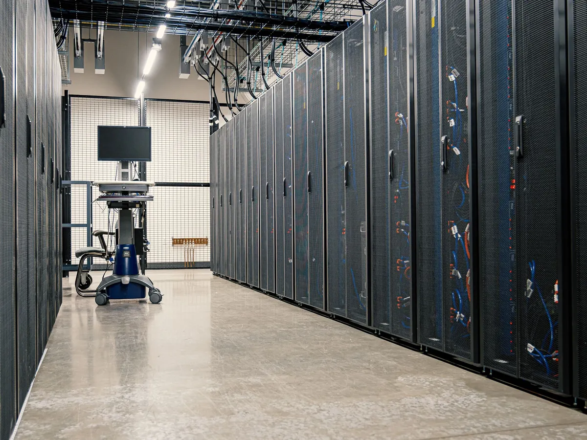 A long data center aisle with an equipment cart