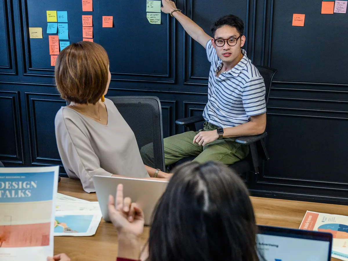 A team mapping its work on a wall of sticky notes