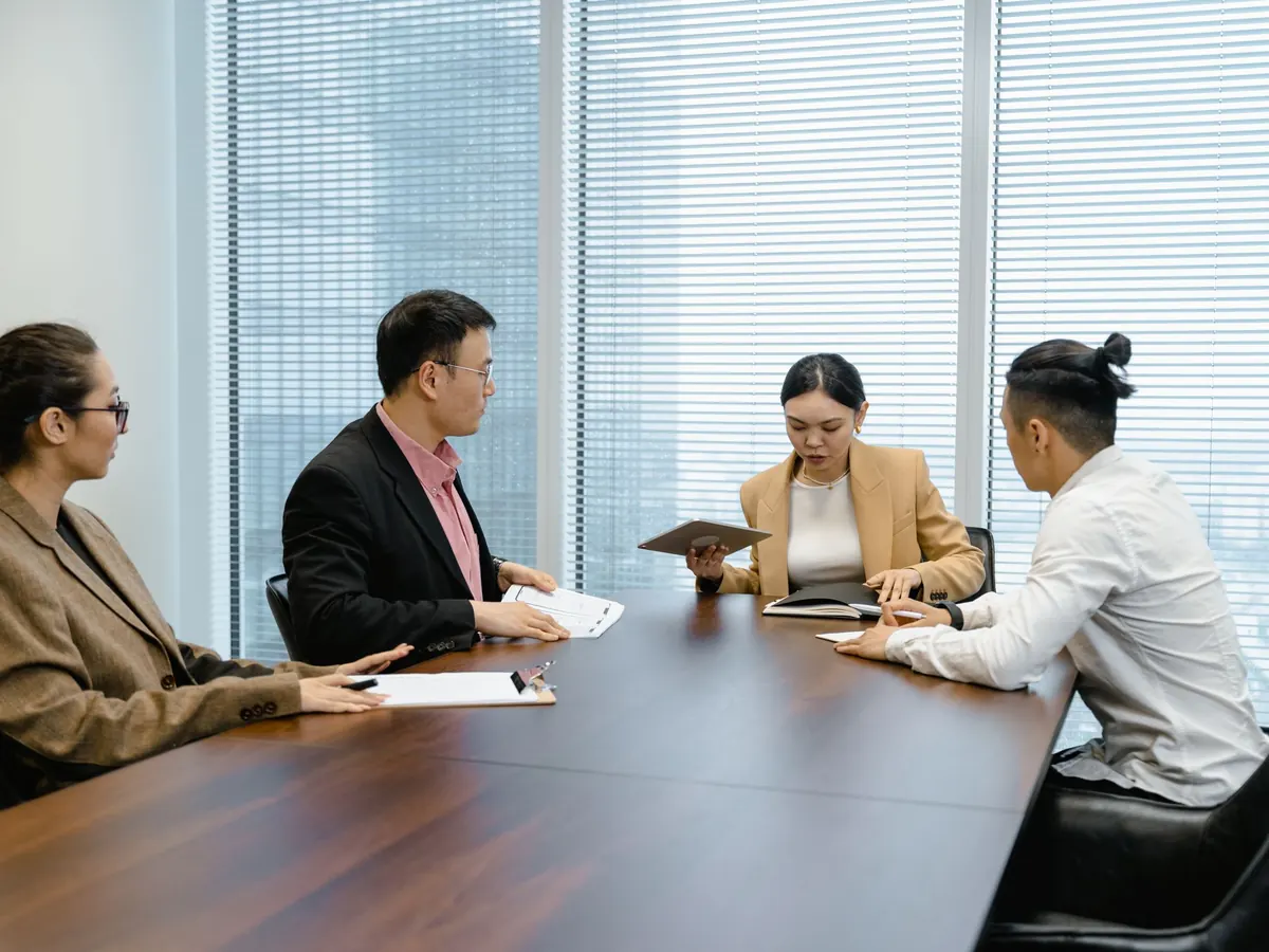 A leadership team deciding around a boardroom table